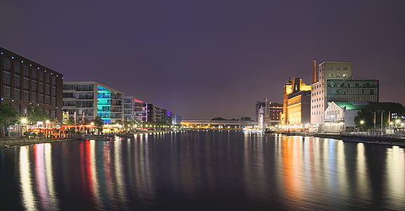 calm body of water between buildings at nighttime thumbnail