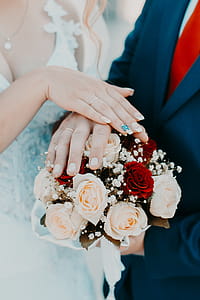 Person Holding Bouquet of White Nad Red Rose thumbnail