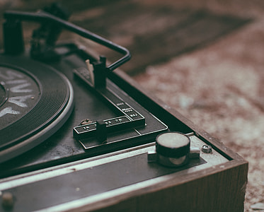 brown and gray vinyl record player on floor thumbnail