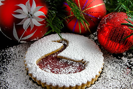 three red christmas baubles beside pie thumbnail