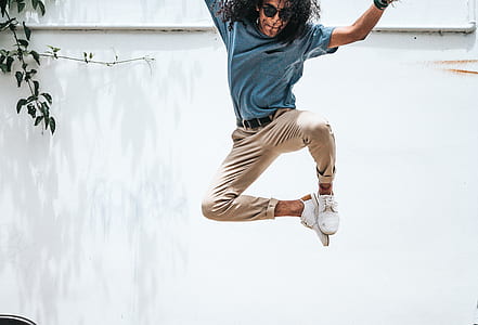 man wearing blue shirt and brown pants jumping thumbnail