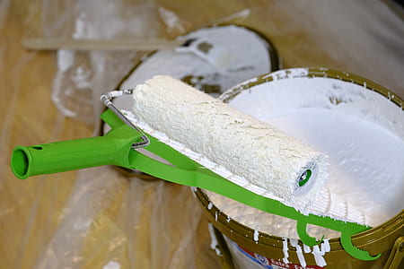 green paint roller on white paint can thumbnail
