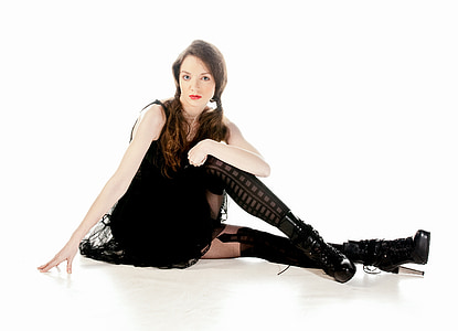 woman wearing black sleeveless dress and boots thumbnail