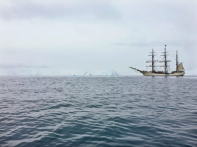 boat sailing on body of water thumbnail