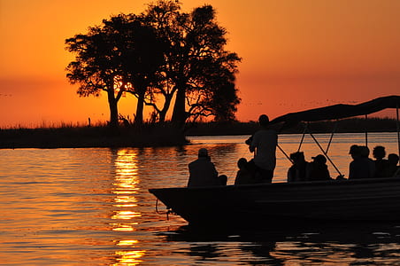 silhouette of people on boat during sunset thumbnail
