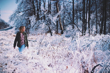woman standing on snow covered flower fields thumbnail