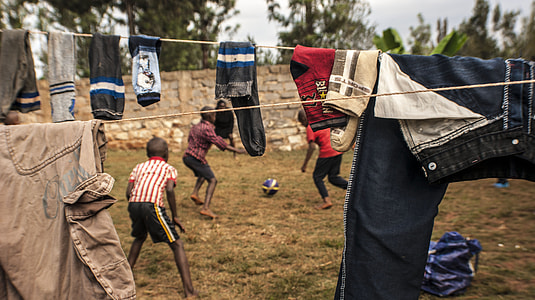 group of boys playing soccer outdoor thumbnail