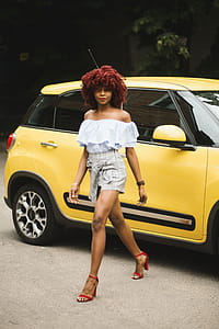 Woman Wearing White Off-shoulder Blouse Standing Next To Yellow Fiat 500l thumbnail