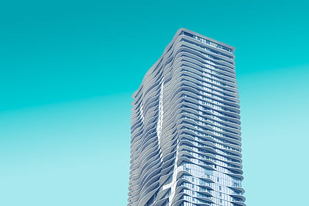 gray concrete building under blue sky during daytime photography thumbnail