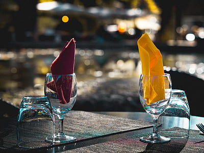four empty glasses on brown and beige textiles thumbnail