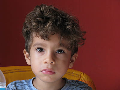 boy sitting on yellow sofa chair thumbnail