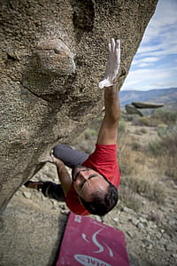 Man Climbing on Gray Concrete Peak at Daytime thumbnail