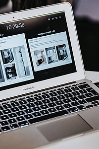 White laptop on a table with a remote thumbnail