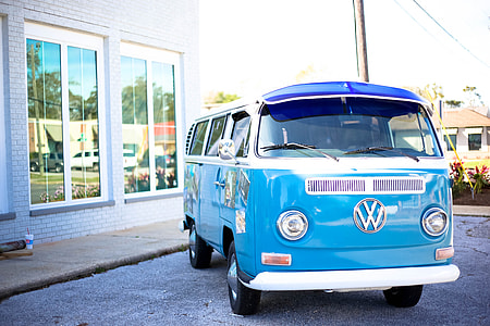 blue Volkswagen T1 parked on gray pavement near building thumbnail