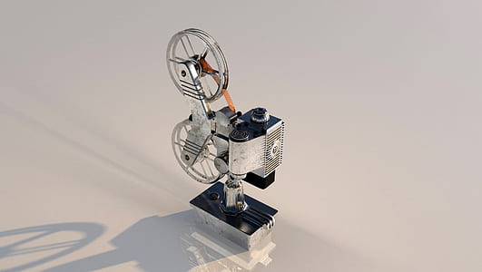 black and gray reel-to-reel camera on white surface thumbnail