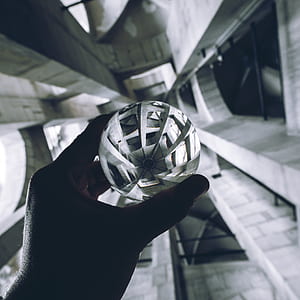 person holding round gray metal ball thumbnail