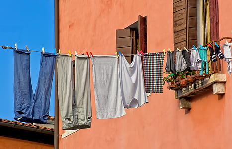 assorted clothes hanging on wire thumbnail