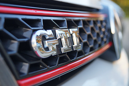 selective focus photography of silver GTI emblem thumbnail