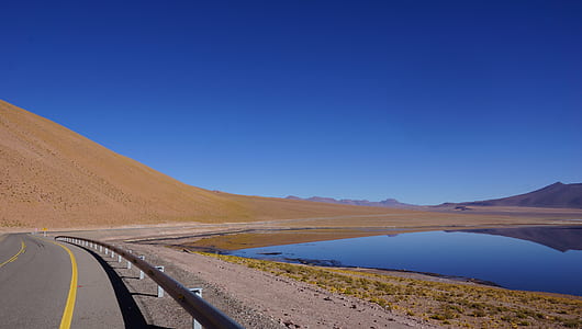 highway beside body of water thumbnail