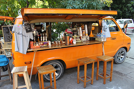food truck near four stools and under the tree thumbnail