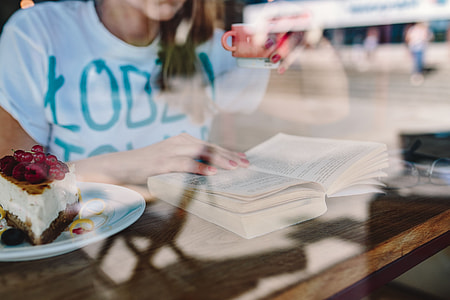 Woman reading book at coffee shop thumbnail
