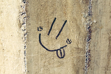 concrete wall with handwritten smiley thumbnail