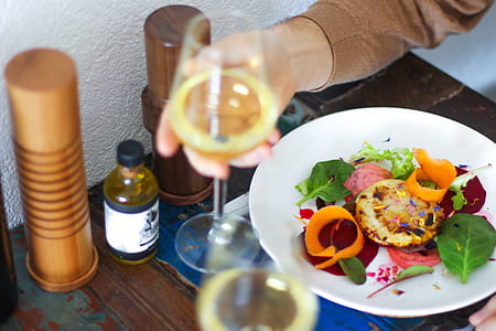 person holding glass of wine thumbnail