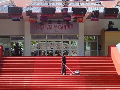 man vacuuming on red stairs thumbnail