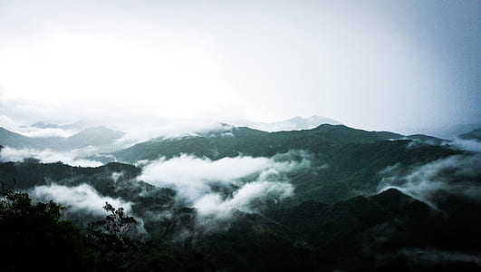 landscape photography of green mountains with white clouds thumbnail