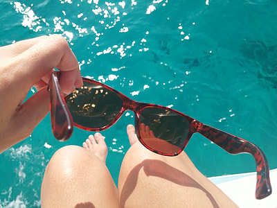 person holding a brown framed wayfarer thumbnail