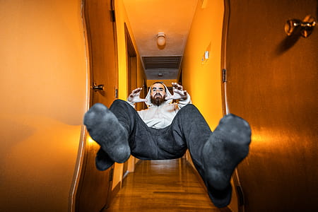 man jumping on pathway near door thumbnail