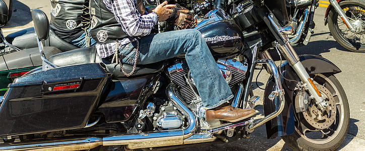man riding black touring motorycle thumbnail