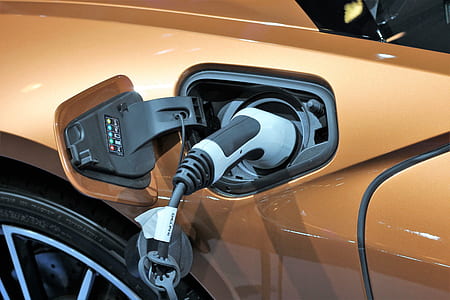gray and black gasoline nozzle in vehicle gas tank thumbnail