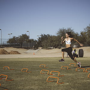 woman jumping on brown steel frames thumbnail
