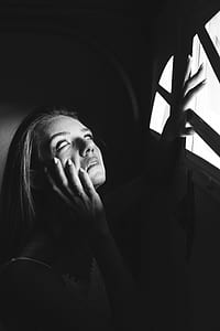 woman holding black window frame thumbnail