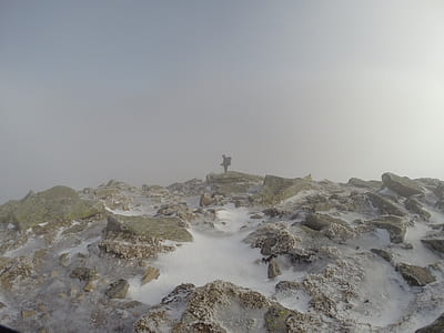 man in the middle of rocky field thumbnail