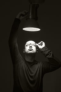 man looking and white lighted pendant light thumbnail