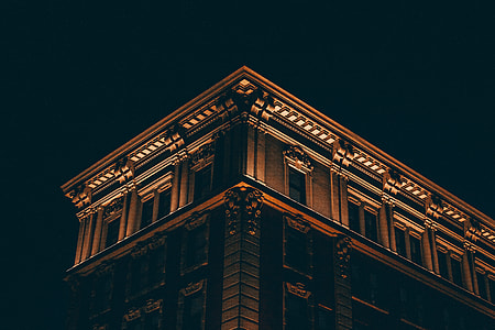 low angle photo of gray lighted building during nighttime thumbnail