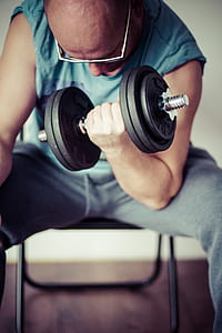 man holding black dumbbell thumbnail