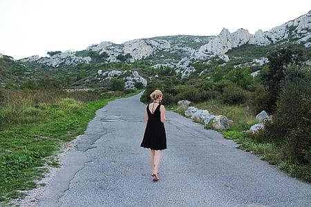 woman wearing black sleeveless dress on gray concrete road thumbnail