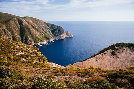 top angle photography of island surrounded by sea water at daytime thumbnail