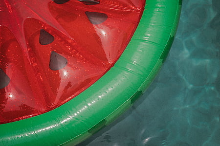 green and red watermelon inflatable floater on water thumbnail