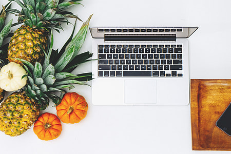 MacBook beside pineapples and squash thumbnail