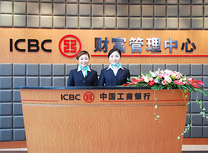 smiling women standing near desk thumbnail