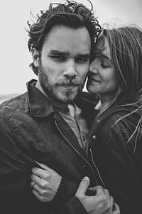 grayscale photography of woman embracing man thumbnail