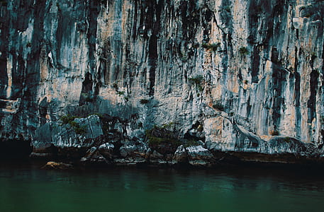 gray fault block mountain near body of water during daytime thumbnail