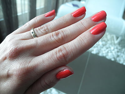 person showing red manicure thumbnail