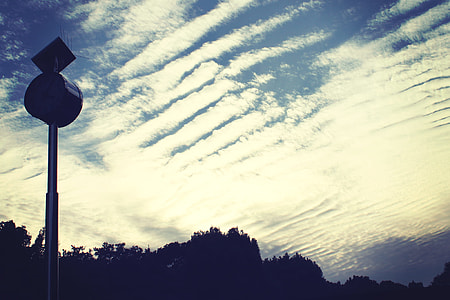 silhouette photography of black utility post and cirrus clouds during daytime thumbnail