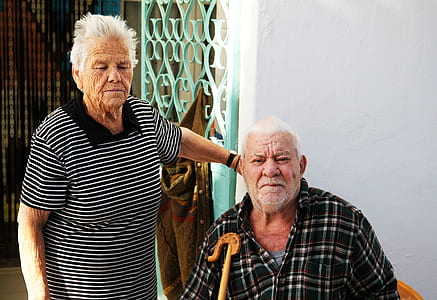 woman standing beside man in black plaid top thumbnail