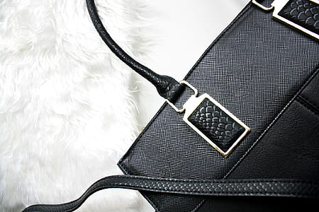 black leather shoulder bag on white textile thumbnail